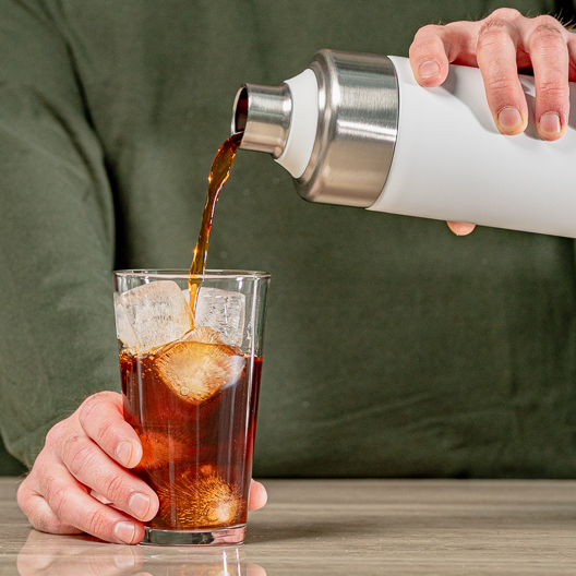 Pouring Cold Brew drink from Go Brewer into glass